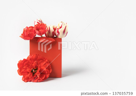 Red shopping and gift bag with red tulip flowers. Concept Valentine's day, gift package and delivery. Sale, shopping, promotion, pleasant surprises, black friday 137035759