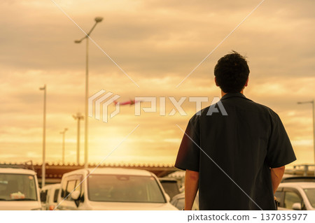 A man seeing off a plane at the airport. Photo courtesy of Kansai International Airport (KIX) A man seeing off a plane at the airport. Photo courtesy of Kansai International Airport (KIX) 137035977