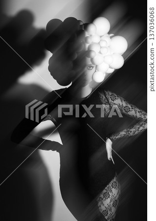 Woman wearing futuristic sphere headpiece in shadow and light 137036068