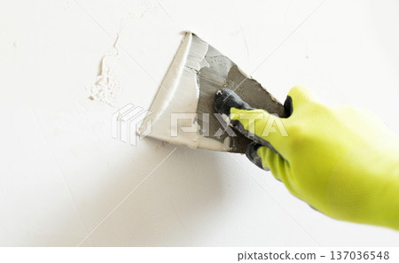Worker Applying Wall Putty With Spatula Worker Applying Wall Putty With Spatula 137036548