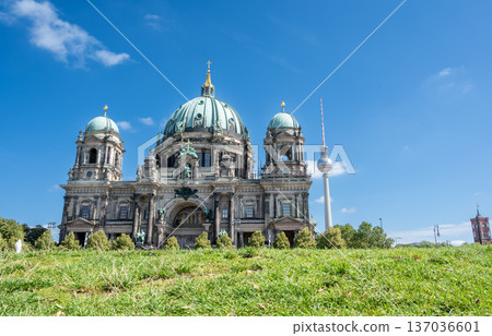 Berlin, germany, august 16, 2023. Berlin cathedral and its green dome with the fernsehturm in the background, showing historic architecture and modern landmark 137036601