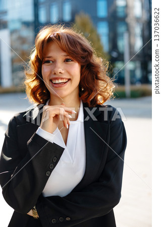 Cheerful Beautiful Businesswoman Smiling In Warm City Light Cheerful Beautiful Businesswoman Smiling In Warm City Light 137036622