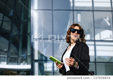 Confident Businesswoman Using Smartphone Outdoors In Corporate Environment 137036659