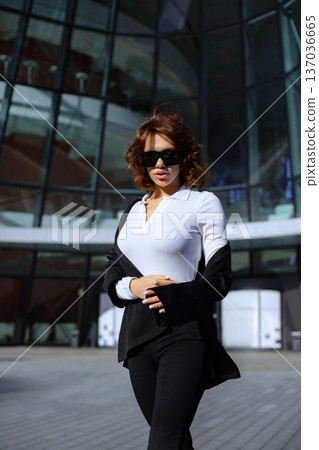 Confident Businesswoman Crossing Arms Near Glass Office Architecture 137036665