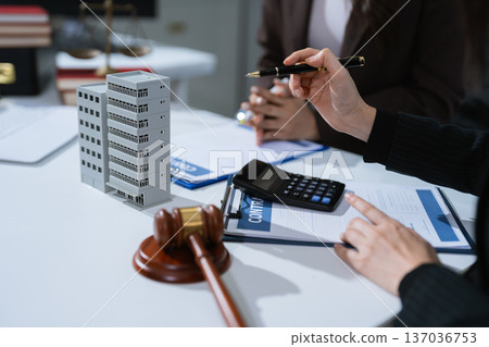 Justice and law concept. Real Estate Law in a courtroom the gavel, working with digital tablet computer. Justice and law concept. Real Estate Law in a courtroom the gavel, working with digital tablet computer. 137036753