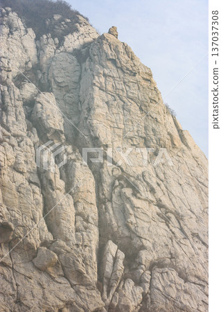 Sunlit granite cliff face Sunlit granite cliff face 137037308