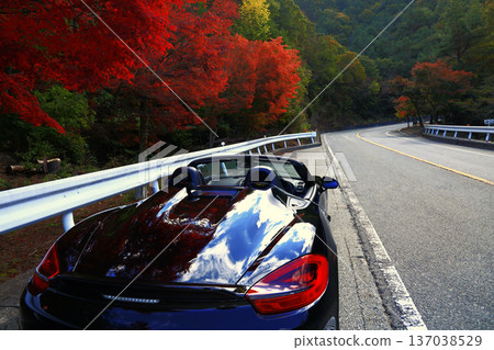 A black convertible car standing on a mountain pass in autumn A black convertible car standing on a mountain pass in autumn 137038529