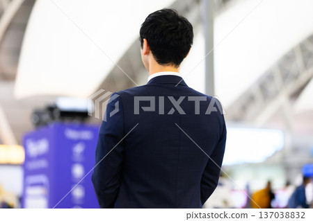 A man in a suit, seen from behind. Photo courtesy of Kansai International Airport (KIX) 137038832