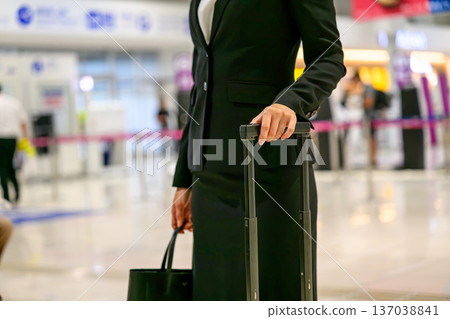 A woman carrying luggage at the airport. Photo courtesy of Kansai International Airport (KIX). A woman carrying luggage at the airport. Photo courtesy of Kansai International Airport (KIX). 137038841