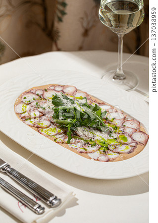 Octopus carpaccio with arugula and parmesan 137038959
