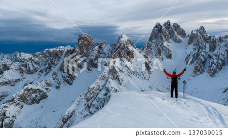 Beautiful Winter Dolomite Mountain Scenery with Man on Cross-Country Skis , Aerial View 137039015