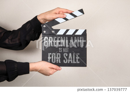 GREENLAND IS NOT FOR SALE Political Statement On Clapperboard Against Neutral Background 137039777