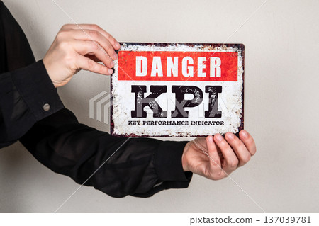 DANGER KPI Key Performance Indicator Warning Sign Held By Hands DANGER KPI Key Performance Indicator Warning Sign Held By Hands 137039781