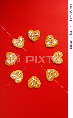 beautiful hand-baked cookies in the shape of a heart on a red background beautiful hand-baked cookies in the shape of a heart on a red background 137039864