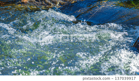 flow of water and spray from a stone flow of water and spray from a stone 137039917