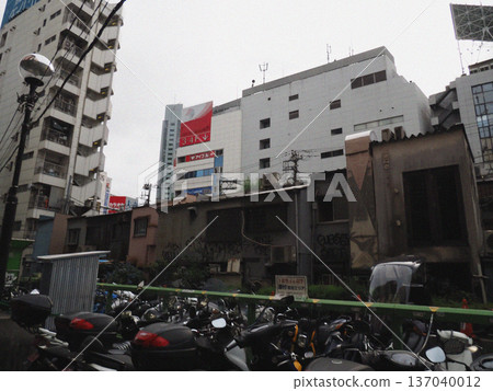 A streetscape photo of the old Shibuya Station area before redevelopment. Illustrated style. 137040012