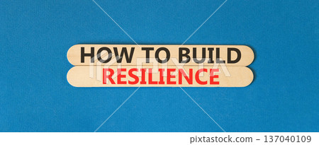 How to build resilience symbol. Concept words How to build resilience on beautiful wooden sticks. Beautiful blue background. Business how to build resilience concept. Copy space. How to build resilience symbol. Concept words How to build resilience on beautiful wooden sticks. Beautiful blue background. Business how to build resilience concept. Copy space. 137040109