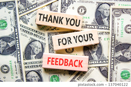 Thank you for your feedback symbol. Concept words Thank you for your feedback on beautiful wooden blocks. Beautiful dollar bills background. Business thank you for your feedback concept. Copy space. 137040122
