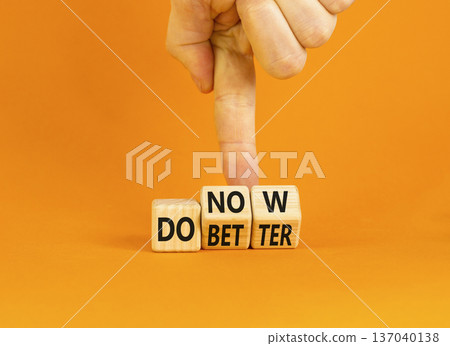 Do better and now symbol. Concept words Do better Do now on wooden block. Beautiful orange table orange background. Businessman hand. Business do better and now concept. Copy space. Do better and now symbol. Concept words Do better Do now on wooden block. Beautiful orange table orange background. Businessman hand. Business do better and now concept. Copy space. 137040138