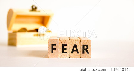 Fear symbol. Concept word Fear on beautiful wooden blocks. Beautiful wooden chest with coins. Beautiful white table white background. Business, lifestyle and fear concept. Copy space. Fear symbol. Concept word Fear on beautiful wooden blocks. Beautiful wooden chest with coins. Beautiful white table white background. Business, lifestyle and fear concept. Copy space. 137040143