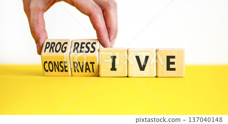 Progressive or conservative symbol. Businessman turns wooden cubes and changes word Conservative to Progressive. Beautiful white background. Business progressive or conservative concept. Copy space. 137040148