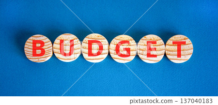 Budget symbol. Concept word Budget on beautiful wooden circles. Beautiful blue background. Business budget concept. Copy space. Budget symbol. Concept word Budget on beautiful wooden circles. Beautiful blue background. Business budget concept. Copy space. 137040183