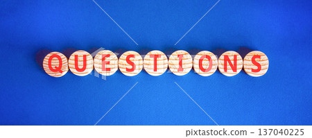 Question questions symbol. Concept word Questions on beautiful wooden circles. Beautiful blue background. Business education support questions concept. Copy space. 137040225