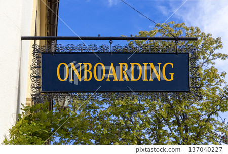 Onboarding success symbol. Concept word Onboarding on beautiful black road sign. Beautiful blue sky and street in Brugge background. Business onboarding success concept. Copy space. Onboarding success symbol. Concept word Onboarding on beautiful black road sign. Beautiful blue sky and street in Brugge background. Business onboarding success concept. Copy space. 137040227