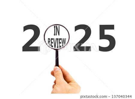 2025 in review new year symbol. Concept words 2025 in review in beautiful magnifying glass. Beautiful white background. Businessman's hand. Business 2025 in review new year concept. Copy space. 2025 in review new year symbol. Concept words 2025 in review in beautiful magnifying glass. Beautiful white background. Businessman's hand. Business 2025 in review new year concept. Copy space. 137040344