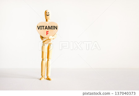 Vitamin F symbol. Concept words Vitamin F on beautiful wooden heart. Doctor's model. Beautiful white background. Copy space. Medical healthy lifestyle Vitamin F concept. Vitamin F symbol. Concept words Vitamin F on beautiful wooden heart. Doctor's model. Beautiful white background. Copy space. Medical healthy lifestyle Vitamin F concept. 137040373