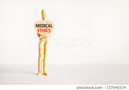 Medical ethics symbol. Concept words Medical ethics on beautiful wooden heart. Doctor's model. Beautiful white background. Copy space. Medical healthy lifestyle medical ethics concept. 137040374