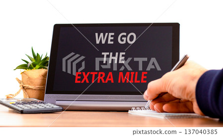 Support, help we go the extra mile symbol. Concept words We go the extra mile on beautiful tablet. Beautiful white background. Businessman's hand. Business we go the extra mile concept. Copy space. 137040385