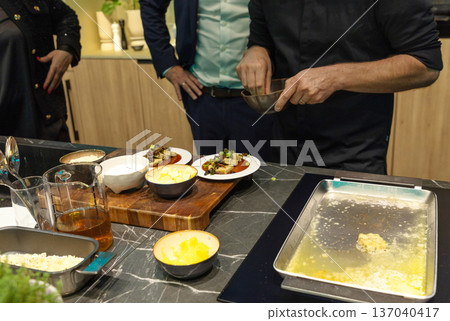 Chef preparing gourmet dishes in modern kitchen with fresh ingredients Chef preparing gourmet dishes in modern kitchen with fresh ingredients 137040417