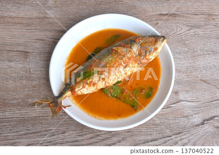 spicy boiled mackerel topping chop lemon grass in red curry sauce on plate spicy boiled mackerel topping chop lemon grass in red curry sauce on plate 137040522