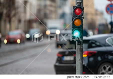 traffic light on the street junction with beautiful bokeh, city with cars in the background 137040566