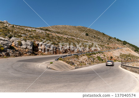 Winding mountain road in Crete, Greece under a clear blue sky Winding mountain road in Crete, Greece under a clear blue sky 137040574