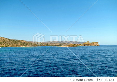 Exploring the tranquil waters and coastline of Crete, Greece under clear blue skies Exploring the tranquil waters and coastline of Crete, Greece under clear blue skies 137040583