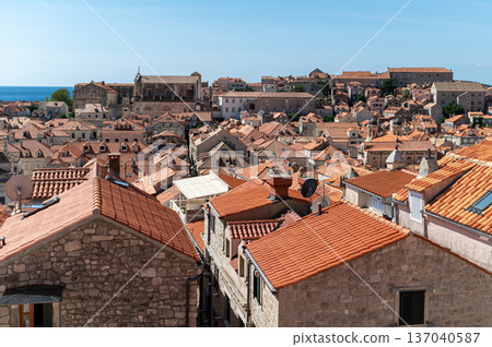 Visitors admire the stunning red rooftops and ancient architecture of Dubrovnik. Visitors admire the stunning red rooftops and ancient architecture of Dubrovnik. 137040587