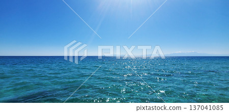 The clear turquoise water of a warm sea under a clear blue sky The clear turquoise water of a warm sea under a clear blue sky 137041085
