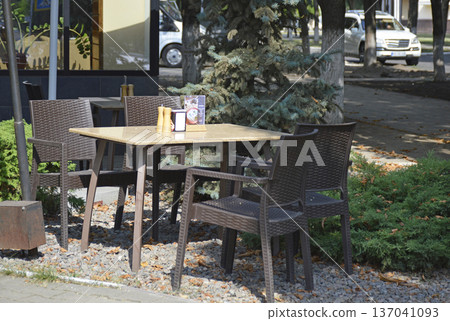 A street cafe with chairs and a table A street cafe with chairs and a table 137041093