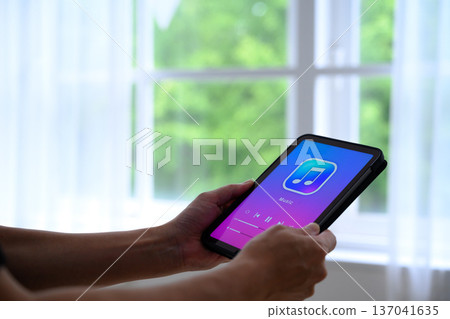 Playing music on a tablet Playing music on a tablet 137041635