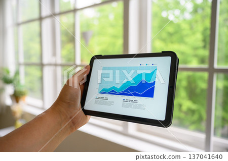 Checking business performance on a tablet Checking business performance on a tablet 137041640
