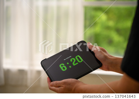 Check the time on a tablet Check the time on a tablet 137041643
