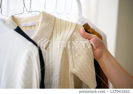 Hands choosing a knit shirt Hands choosing a knit shirt 137041682
