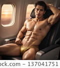 Handsome Male Model in Vibrant Fashion Swimwear Relaxing in Luxury Airline First Class Suite 137041751