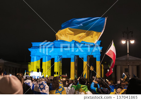 Ukrainian and Polish Flags Wave at Brandenburg Gate Lit Blue and Yellow in Berlin 137041865