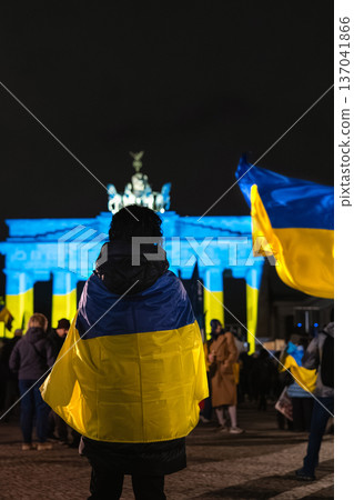 Protester Draped in Ukrainian Flag Faces Brandenburg Gate in Berlin Protester Draped in Ukrainian Flag Faces Brandenburg Gate in Berlin 137041866