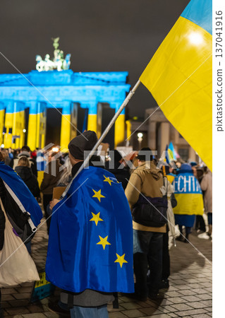 EU Cape and Ukrainian Flag in Front of Brandenburg Gate Lit Blue and Yellow 137041916