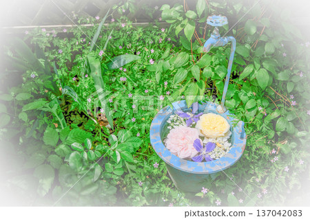 Antique-style blue bucket and faucet flower display 137042083