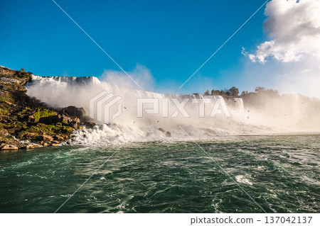 Niagara Falls wide panoramic waterfall with mist rising above powerful river 137042137
